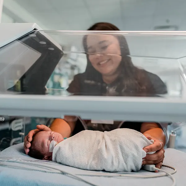 A healthcare professionals tends to a newborn