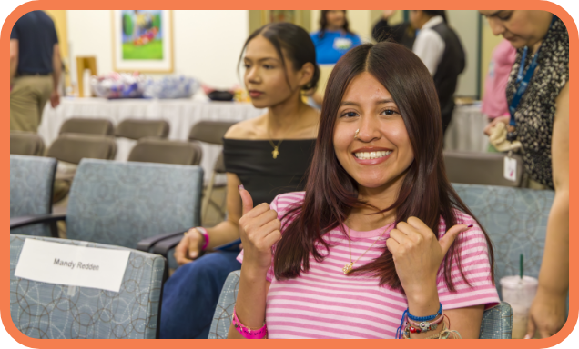 A recipient of a scholarship smiles