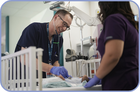 NICU doctor attends to a patient in a crib