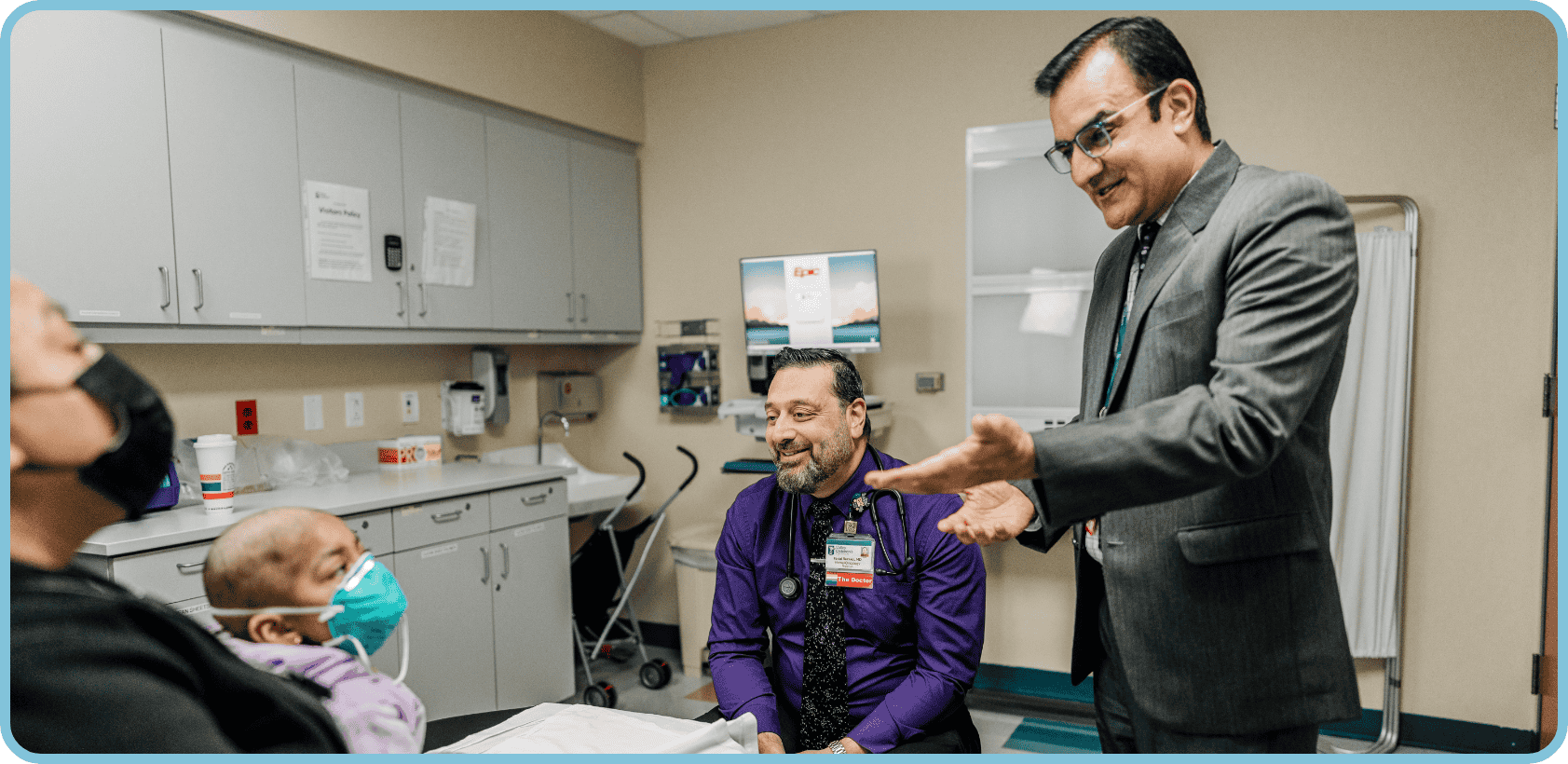 Drs. Razzaqi and Sharma talk with a patient and family