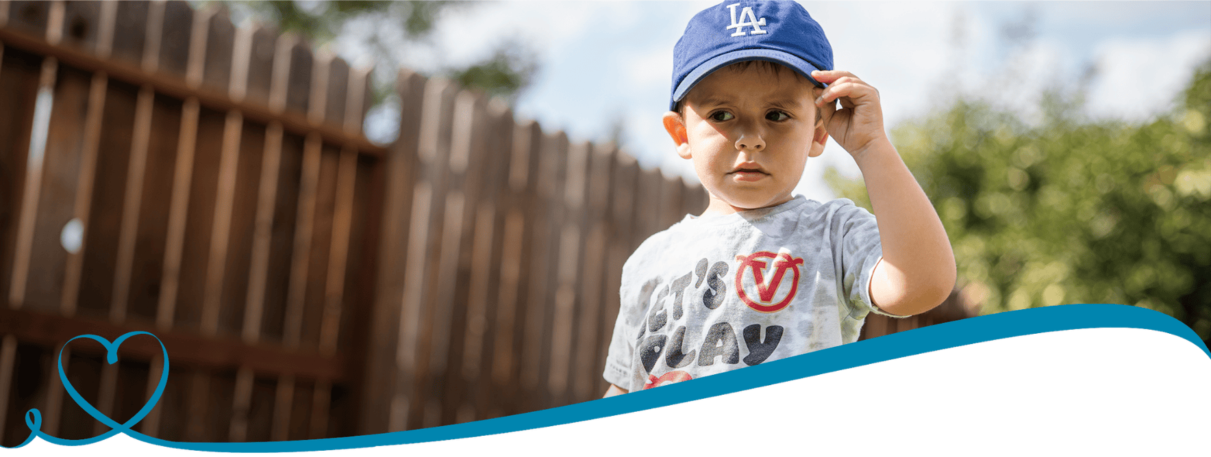 A young boy plays outside