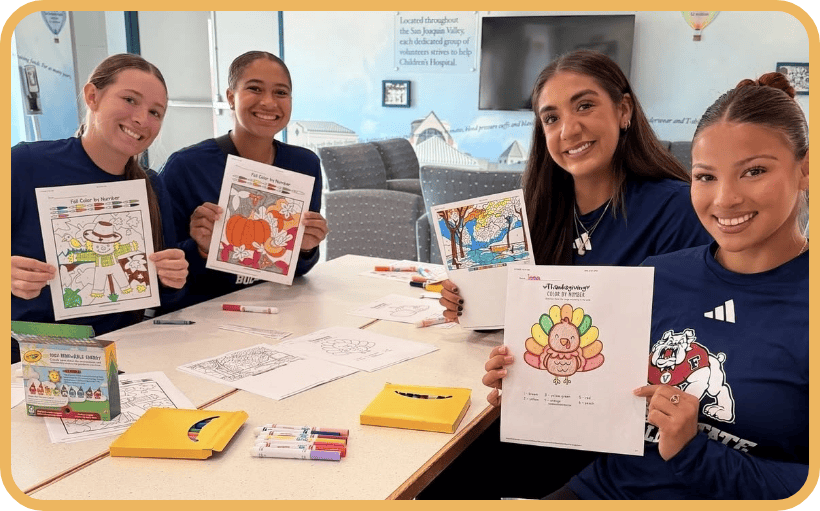 Members of the Fresno State volleyball team color in the Guilds Hall