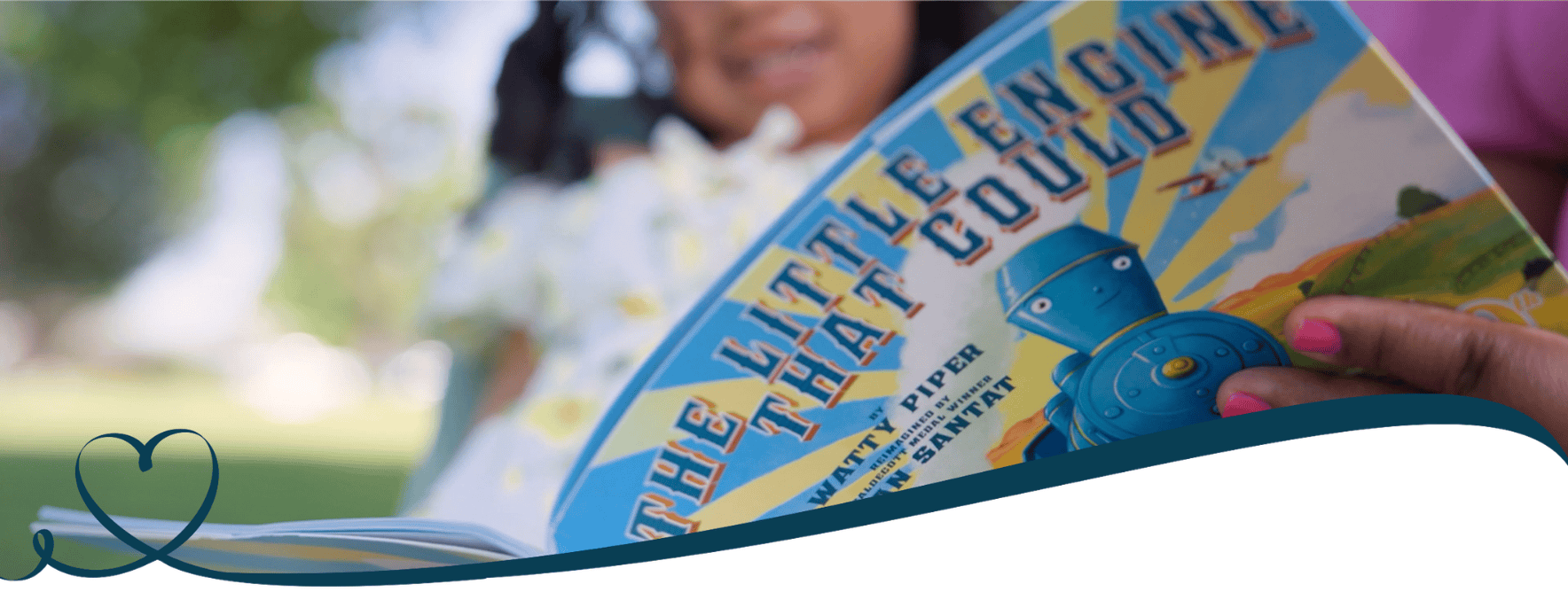 A little girl and her mother read a book