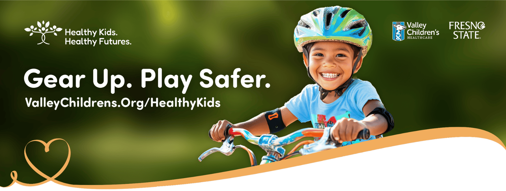 A young girl rides a bike and smiles