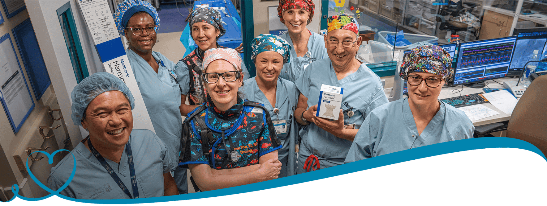 Members of the cardiology team smile with the Medtronic valve
