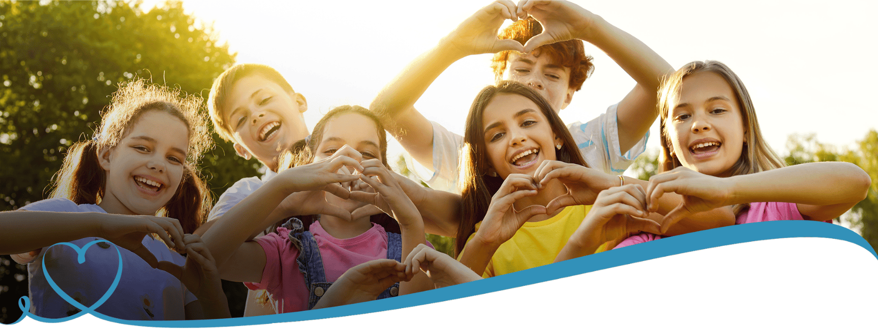 A group of children smile in the sunset