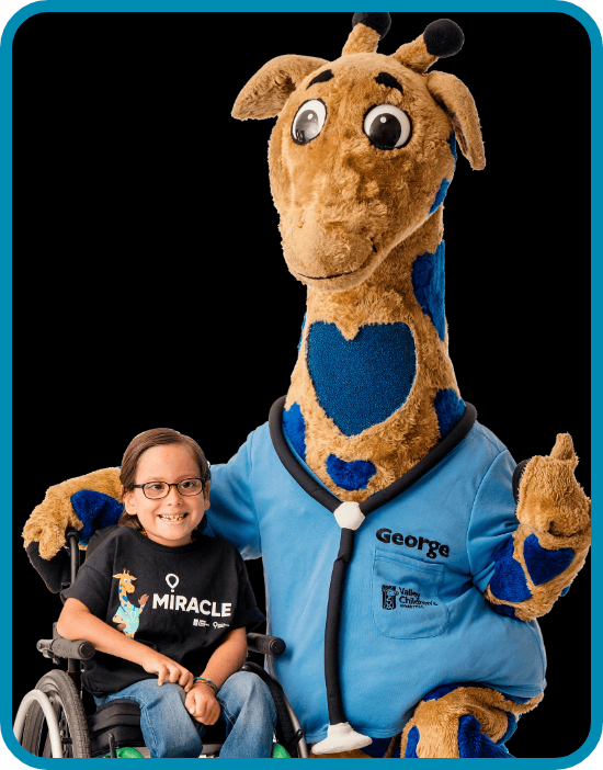 Sylus smiles with George the Giraffe