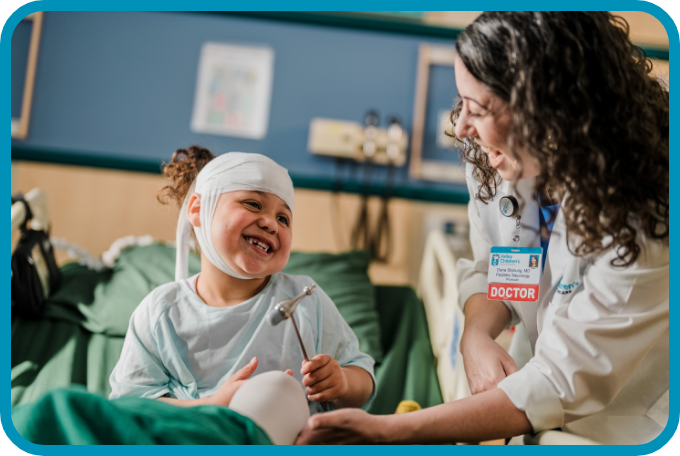 A doctor smiles at a young patient
